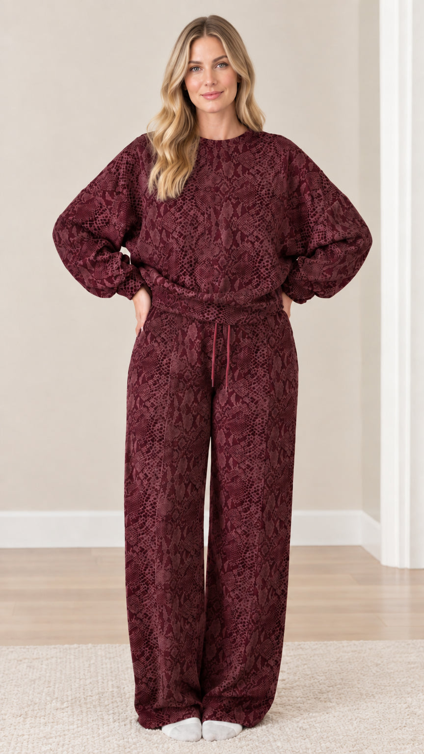 Front view of model wearing deep burgundy red snakeskin print matching lounge set