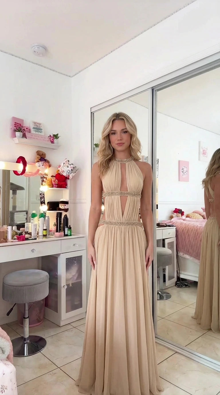 Model wearing champagne beige halter cutout evening maxi gown with delicate beading