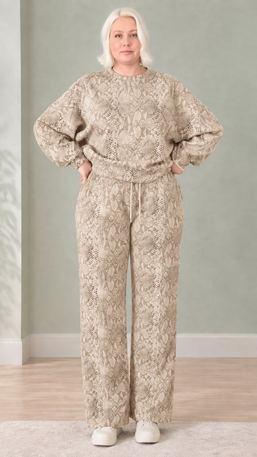 Woman wearing beige taupe snakeskin print sweatshirt and wide-leg pants set