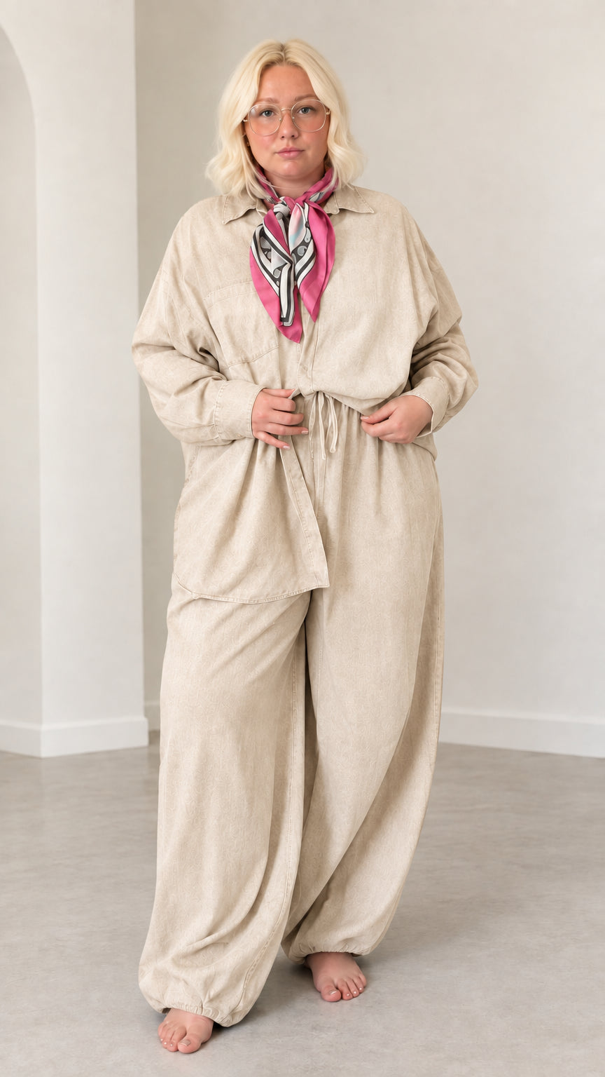 Front full-length view of model wearing Beige matching shirt and lantern pants set
