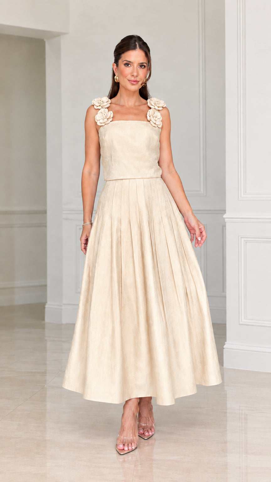 Front view of woman wearing champagne cream floral strap pleated midi dress