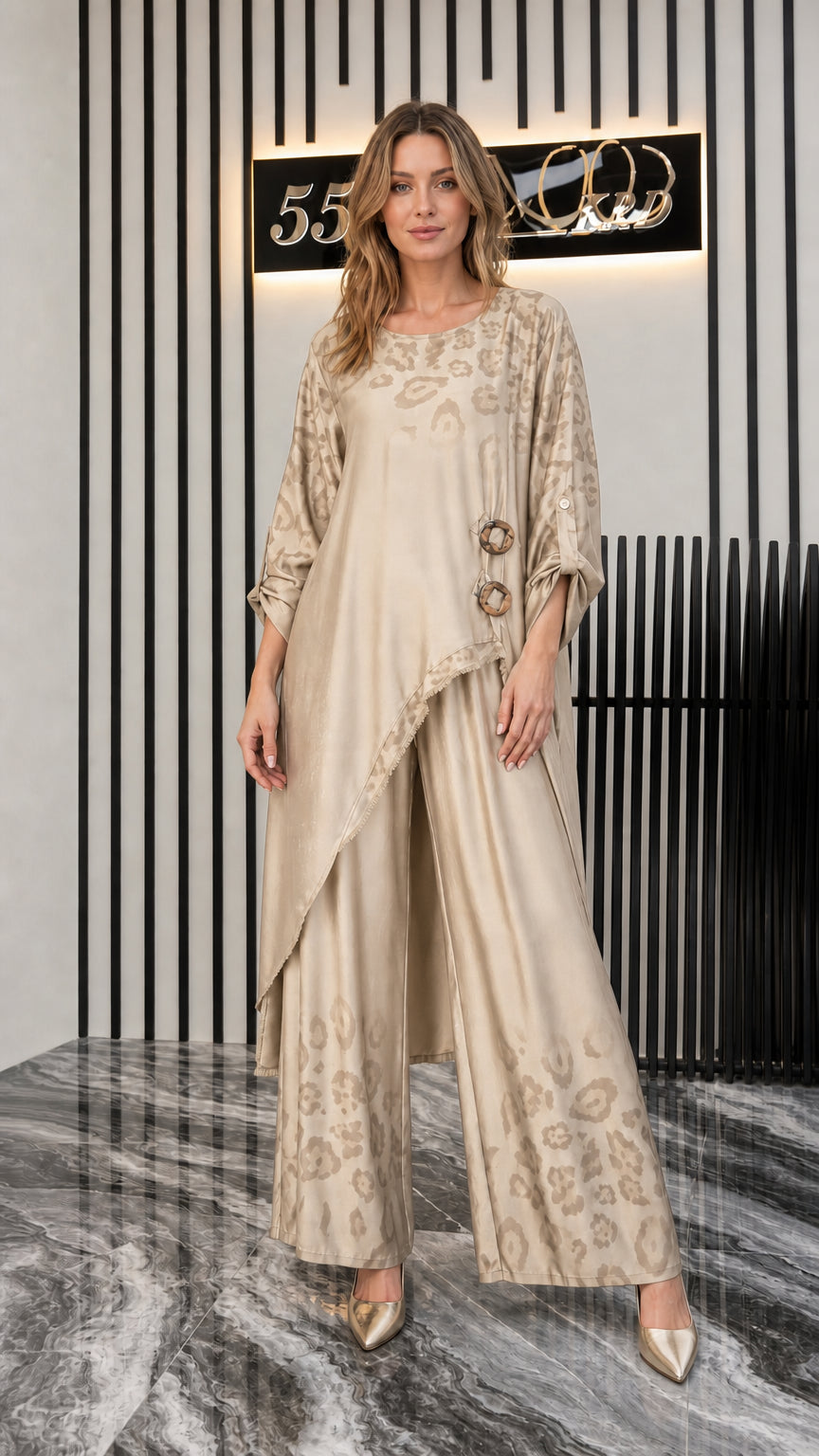 Front view of woman wearing champagne beige draped tunic and wide-leg pants set