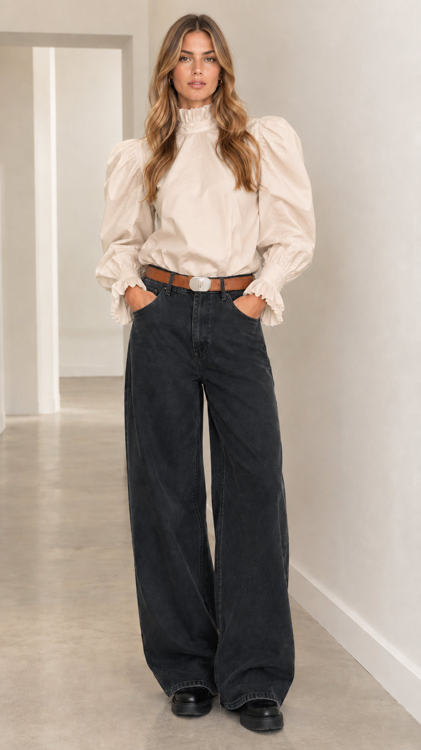 Woman wearing cream beige ruffle high-neck puff-sleeve blouse with dark wide-leg casual pants