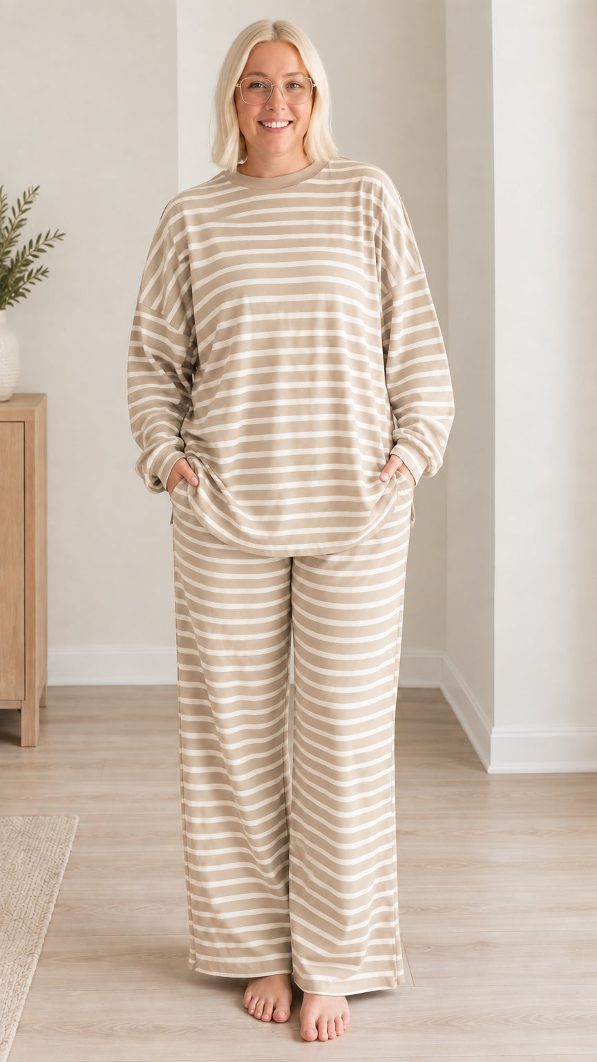 Front view of woman wearing beige striped long sleeve pajama set