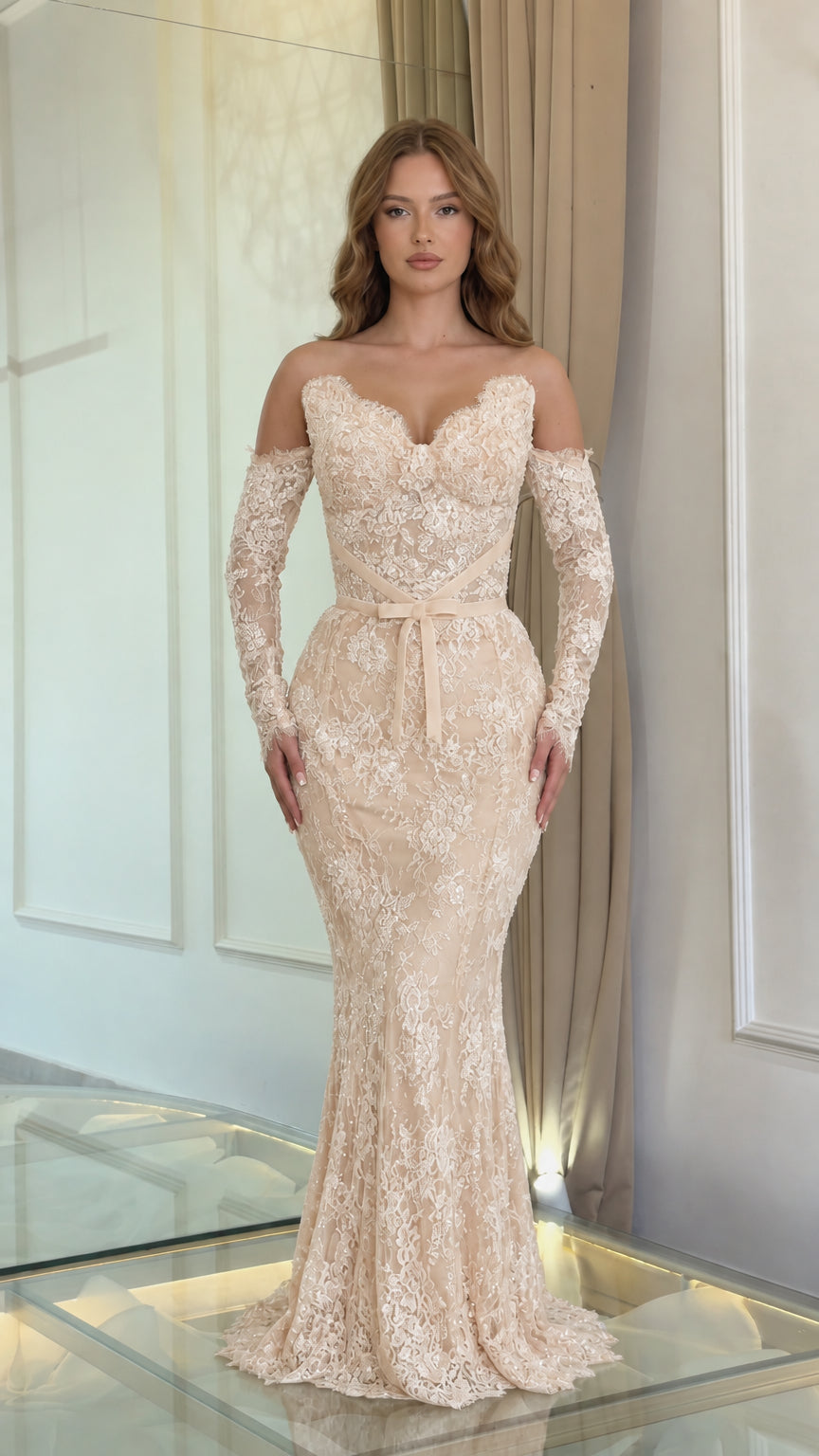 Full front view of a model wearing a champagne beige lace off-the-shoulder mermaid formal gown