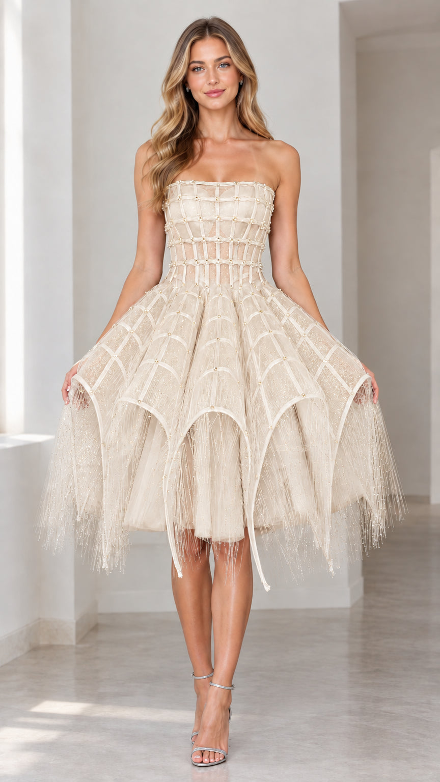 Front view of champagne beige strapless embellished corset cocktail dress with tiered fringed skirt