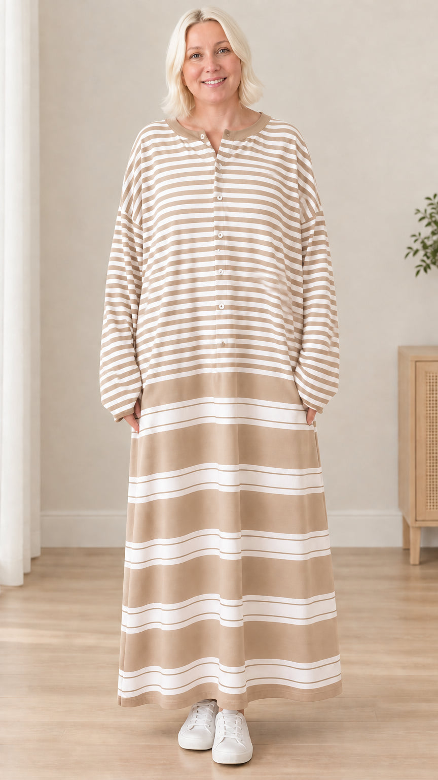 Front view of woman wearing beige striped long sleeve maxi dress