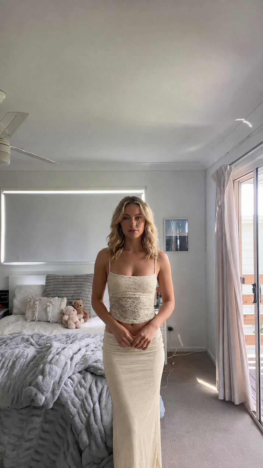 Model wearing beige cream lace cami top and matching maxi skirt two-piece set