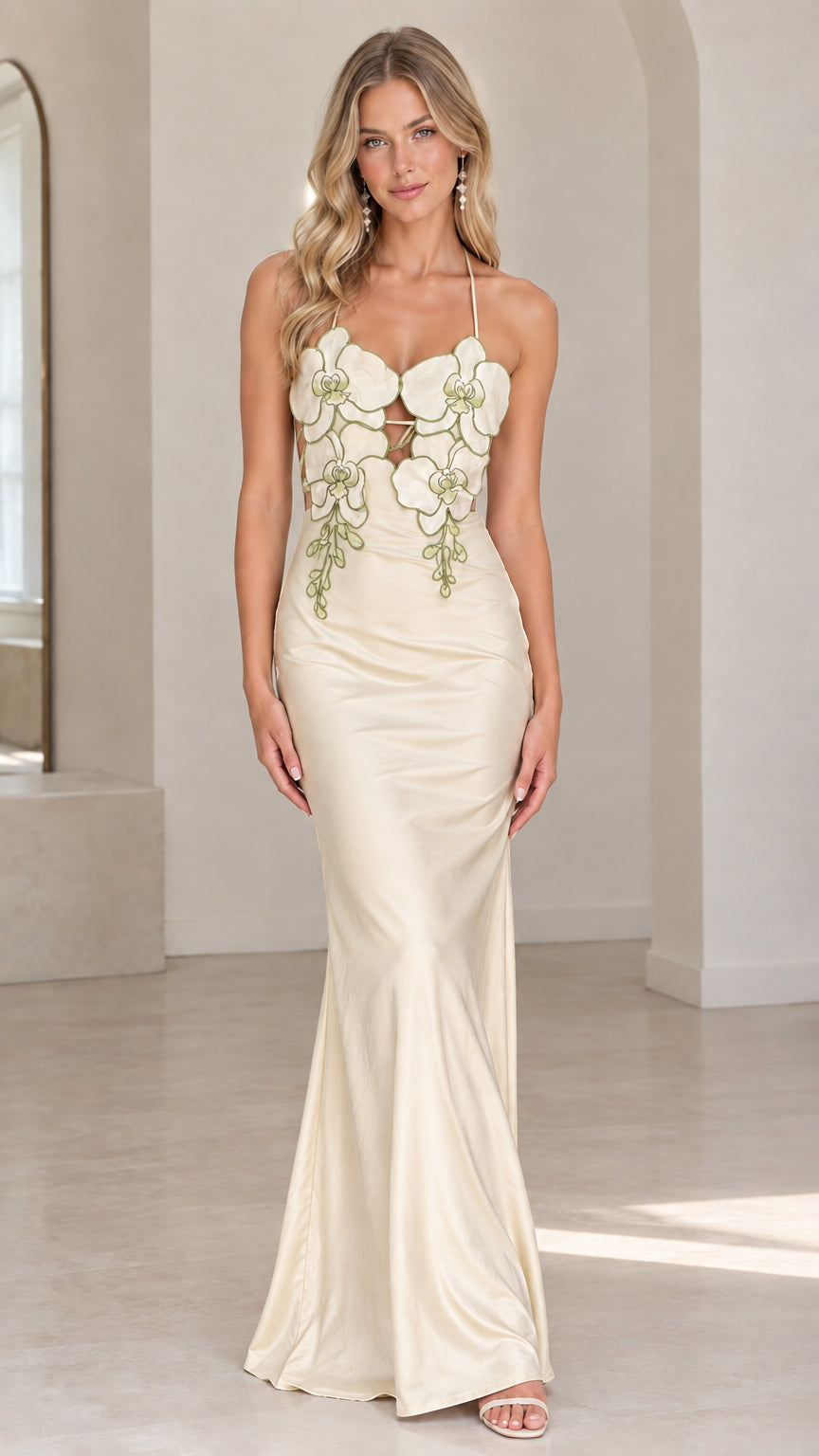Front view of model wearing champagne ivory satin halter maxi dress with floral appliqués