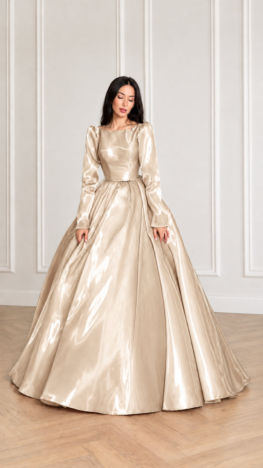 Front view of model wearing champagne gold glossy long sleeve satin ball gown