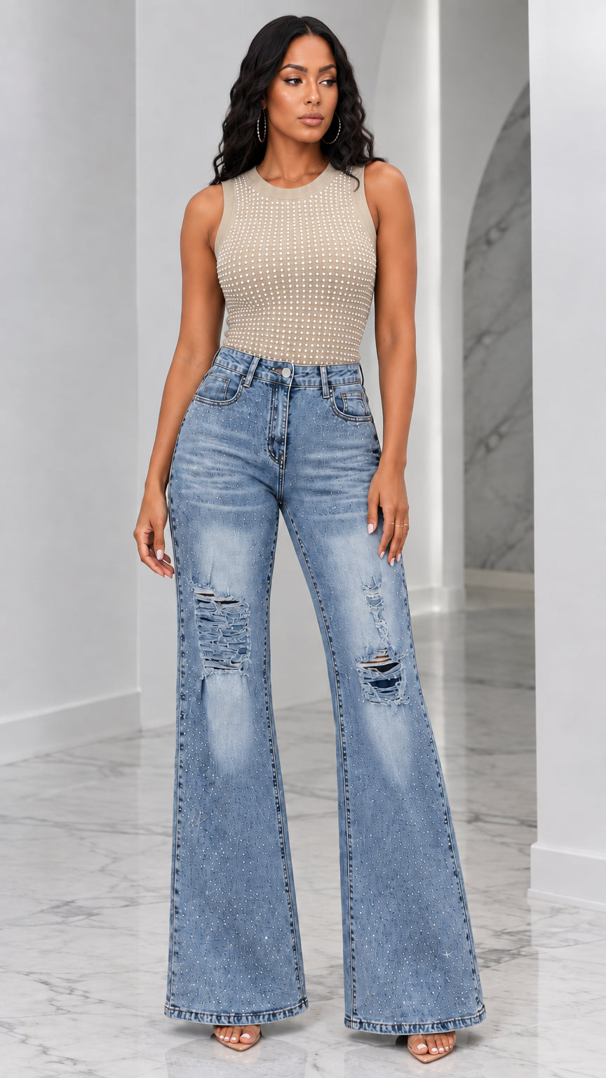 Full-length view of woman wearing beige khaki rhinestone tank top and distressed flare jeans