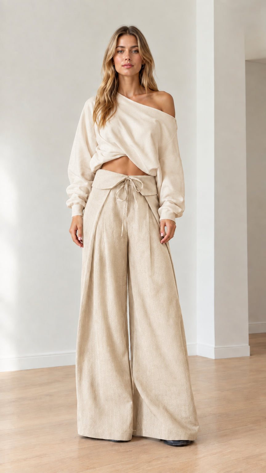 Model wearing matching beige off-the-shoulder top and wide-leg pants set
