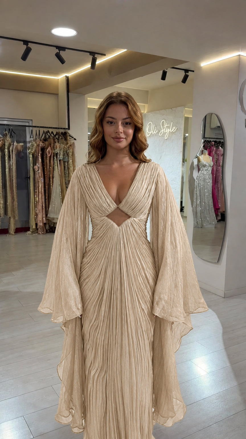 Full front view of champagne beige pleated cutout evening gown with cape sleeves