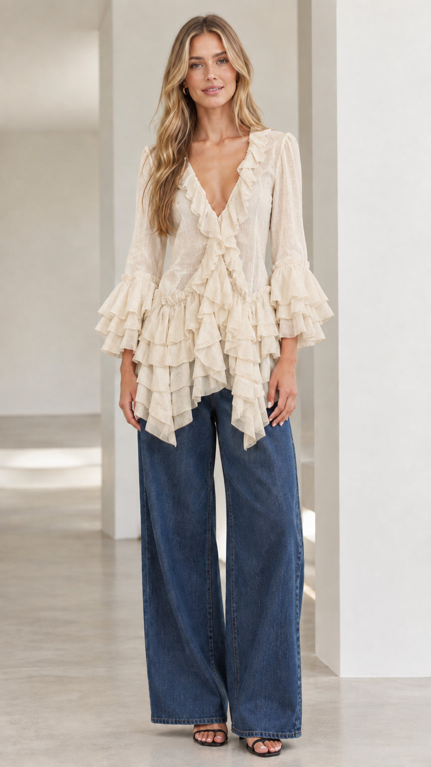 Model wearing beige cream tiered ruffle bell sleeve top