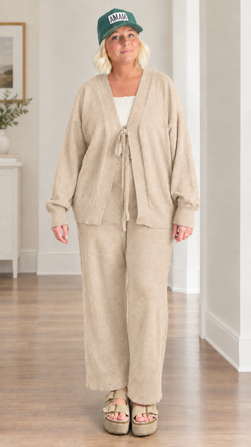 Woman wearing beige knit tie-front cardigan and matching wide-leg trousers