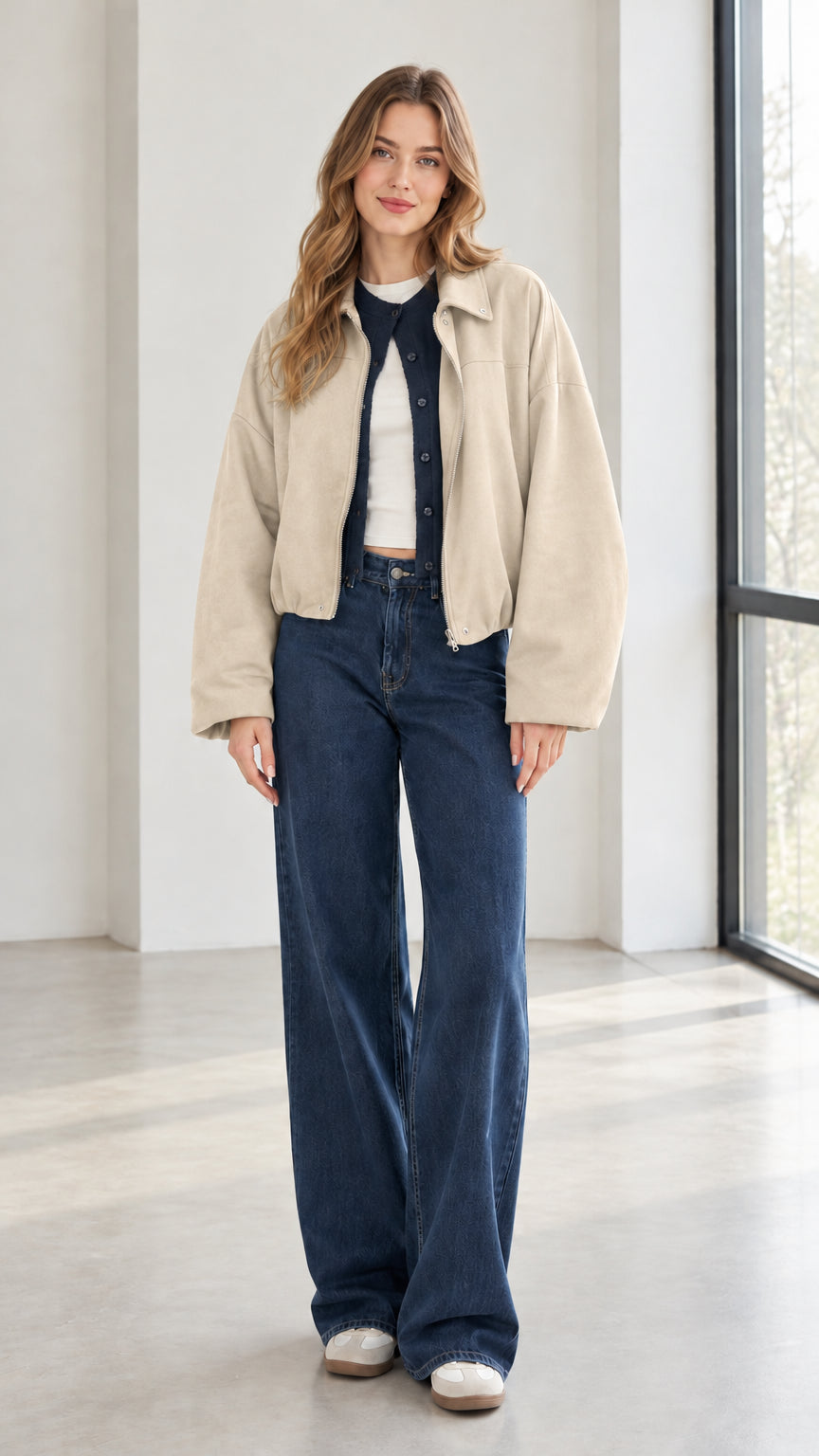 Woman wearing beige cream collared zip-up jacket with denim pants