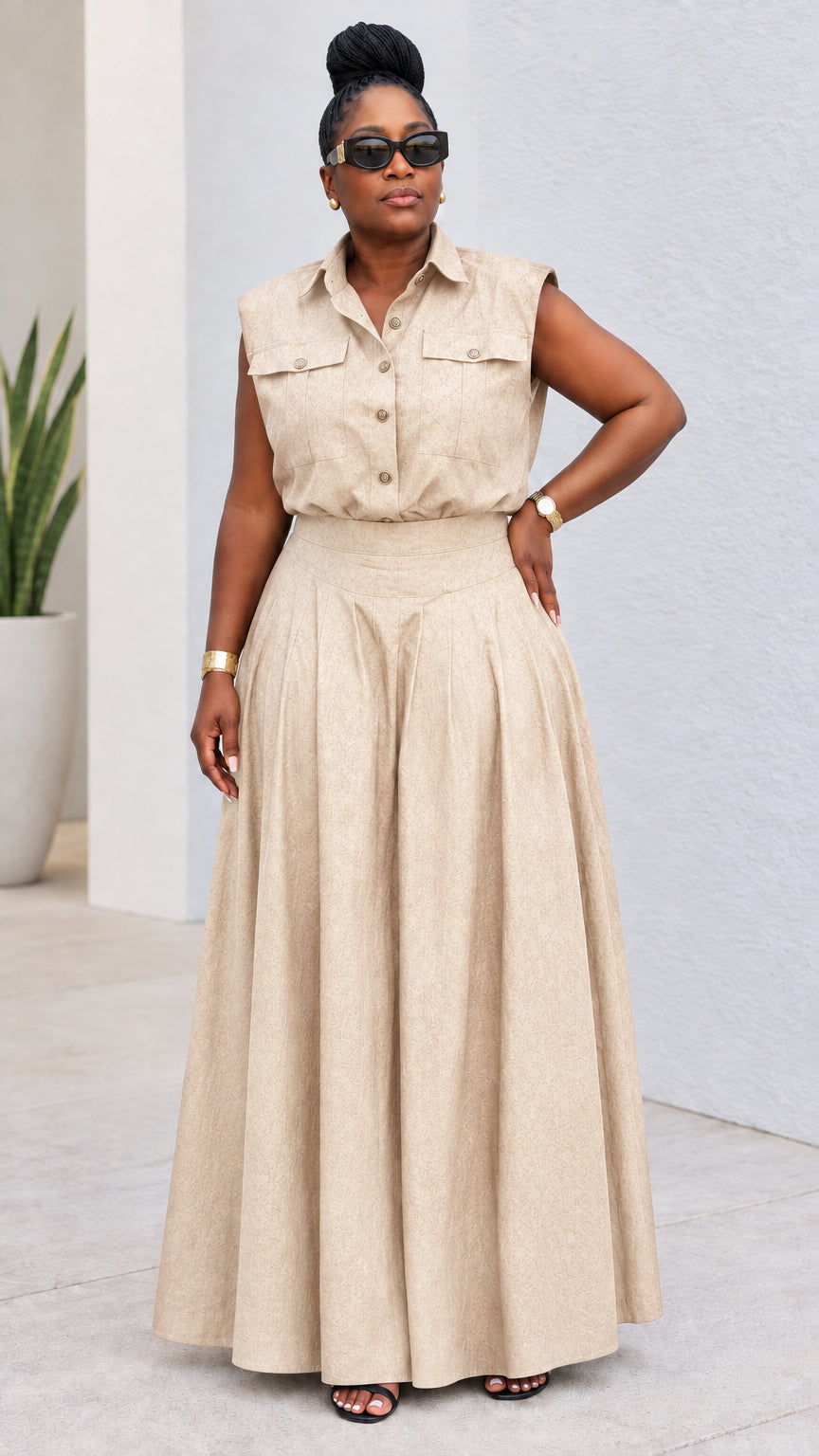 Model wearing beige sleeveless utility shirt and pleated maxi pant set