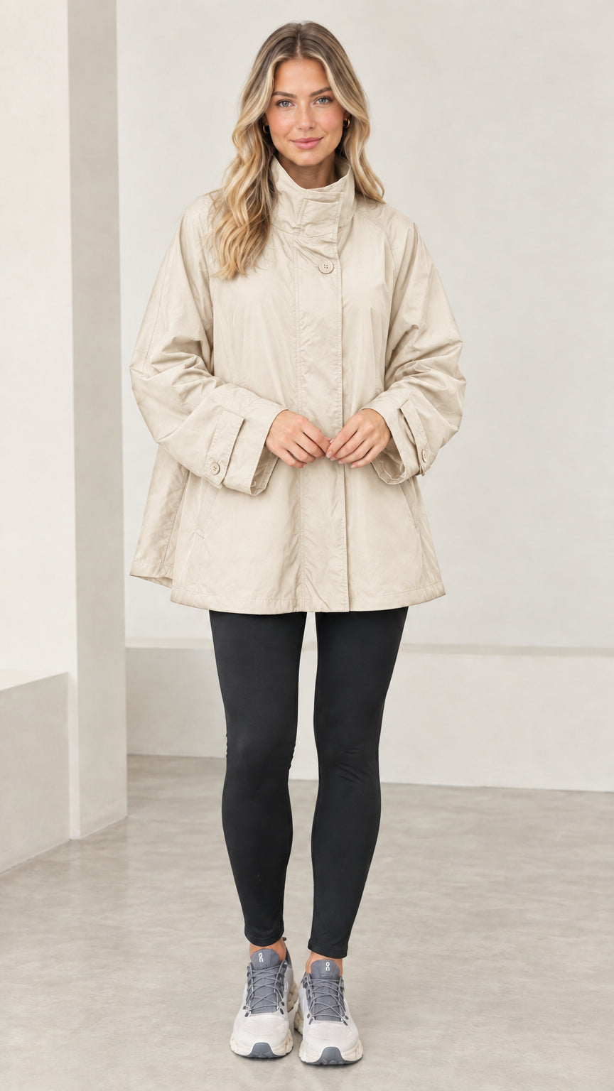 Front view of model wearing beige lightweight swing coat